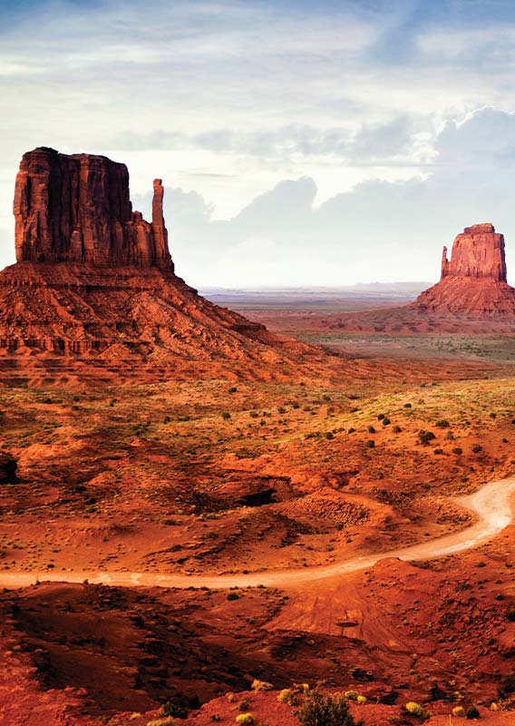 A view of tall rocky buttes in the desert.